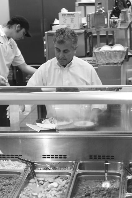Mounir Saleh, owner of Neomonde Restaurant, prepares a platter for a customer. "We open zero cans here; all of our ingredients are fresh. Lots of N.C. State staff and professors eat here but I'd like to see more students in the restaurant," Saleh said. "Since the food is so healthy and we have tons of vegetarian dishes, eating at Neomonde would be a great way to fight the freshman 15," Saleh laughed. Photo by Alex Canoutas