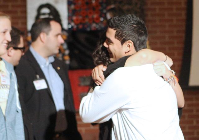Saul Flores, a senior in graphic design and marketing, hugs one of the audience members at the TEDxNCSU event in Talley Student Center Saturday, Oct. 23, 2010. Flores made a journey called the Walk of the Immigrants, from Ecuador to the United States, to raise money and awareness for less-privileged kids in Latin America. Along his journey, Flores kept a photo journal, noting distinctions between the 10 different countries he traveled through. Photo by Lee Daniello