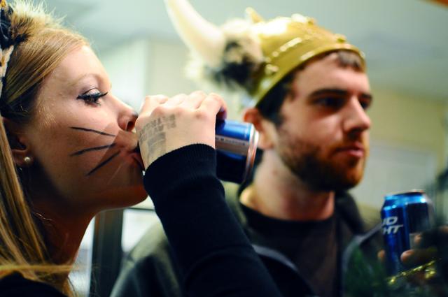 Jessica Nomina, alumna, drinks a Bud Light with Andrew Haley, a senior in English, after finishing a slice of cheese pizza in Sylvia's Pizza during the Haunted Hillsborough Hike Saturday, Oct. 30. Sylvia's, like other places on Hillsborough Street, offered a special &#8212; buy a pizza and beer for $5. "The best part of the Hike is choosing Hillsborough over Franklin," Nomina said. Photo by Luis Zapata