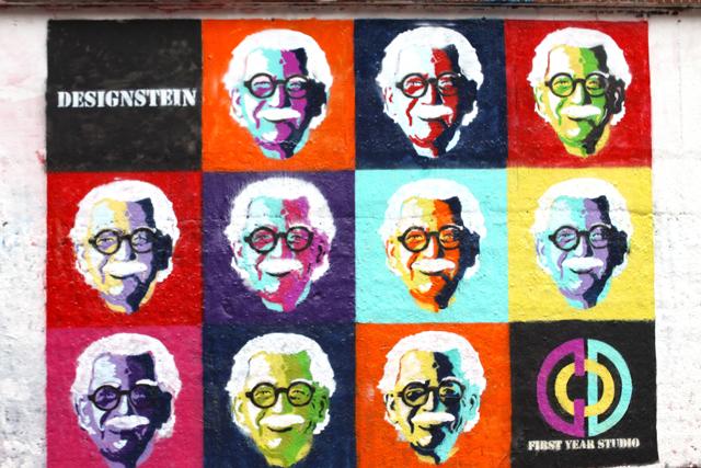 The Andy Warhol-inspired collage of Marvin Malecha, dean of the College of Design, was designed and stenciled by first-year studio students after seven hours of hard work Monday morning. Each face required the use of multiple stencils for each layer of spray paint added. Photo by Mikayla Craig