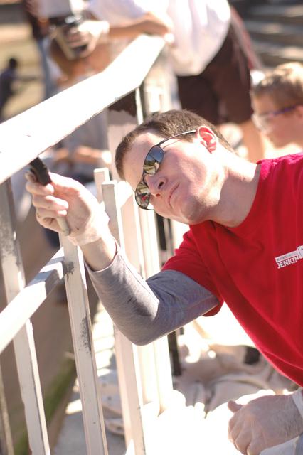 Eddie Hoffman, a first year MBA student, paints the underside of a handrail at Pullen Park Friday. Hoffman was working with other volunteer MBA students and candidates in painting the iron railings in Pullen Park, which were in need of repair. "The idea was brought up by MBASA, and I just hopped on board.