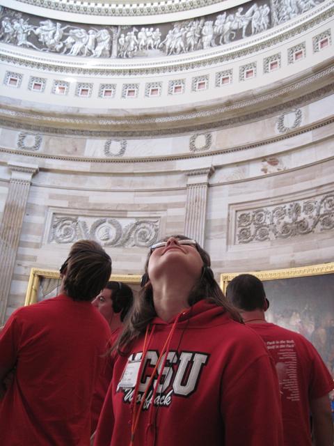 Emily Talley, a sophomore in poultry science, gazes up at the dome inside the Capitol Building&#8217;s rotunda during a guided tour. Photo by Zachary Diezel