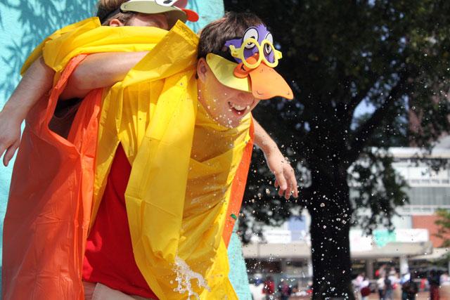 Ethan Bartlett, Student Government Chief of Staff and junior in economics, puts Kyle Winters, Inter Residence Council president and senior in business administration, in arm lock preparing him to be hit by water balloons during Delta Upsilon's Duck Hunt on Wednesday, Oct 13. Duck Hunt was a charity event profiting the Keto Community School near Negril, Jamaica.