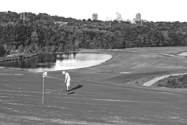 Lining up his shot, John Tart, a senior in poultry science, putts on the 18th green at Lonnie Poole Golf Course on Centennial Campus. &#8220;It&#8217;s really convenient having a golf course located so close to campus,&#8221; Tart said. &#8220;It&#8217;s a really nice course.&#8221; Photo by David Hawley