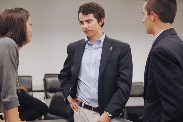 After the Student Senate meeting Wednesday, student government assistant director Eileen Coombes, Matt Tucker, a junior in environmental technology, and John Tucker, a sophomore in political science, discuss possible options for the future of the Free Expression Tunnel. After incidents of indecent graffiti on the walls of the Tunnel, the University is still deciding whether to continue to allow students to draw in the Tunnel, or to close it off completely. Photo by Lee Daniello