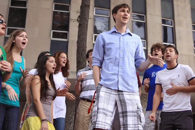Geoff McDaniel, a sophomore in biological sciences, sings with other members of Acappology in the Brickyard during the unveilling of the new Chancellor&#8217;s Choice ice cream. &#8220;It was a big turn out. I was glad we got to come out and represent Acappology,&#8221; McDaniel said. &#8220;I wish good luck to the new chancellor. I feel like he&#8217;s had a long two days.&#8221; Photo by Marisa Akers