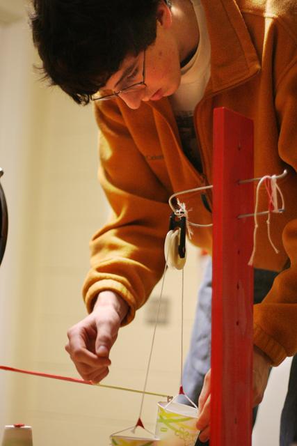 Taylor Russell, freshman in aerospace engineering, adjusts a component of his E101 freshman design project. Photo by Luis Zapata