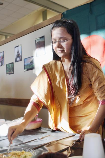 Mahbuba Iasmin, a doctoral student in civil engineering, serves food at the Interational Tea and Coffee party in Caldwell Hall Wednesday. Representing Bangladesh, Iasmin served jhal muri, a traditional spicy Bangladeshi dish made with puffed rice. Photo by Aaron Andersen