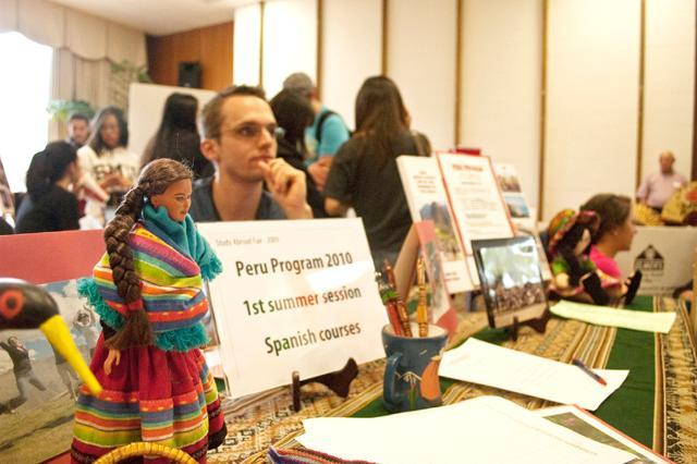 A volunteer sits at the Peru Program table during the 2010 Study Abroad Fair. Peru is one of the most popular countries in the Study Abroad program. Photo by Nick Yelle