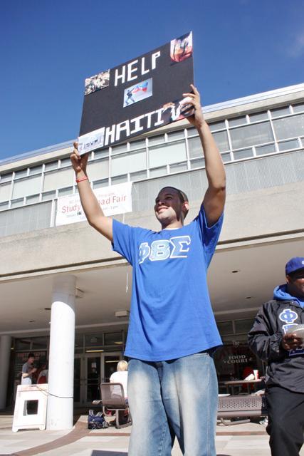 Elvin James, a junior in First Year College, holds up a "Help Haiti" sign in front of the Atrium Tuesday, Jan. 19, 2010. "We're from the Xi Zeta chapter of Phi Beta Sigma," James said. "We're collecting money for the Haiti relief; we're accepting donations." The fraternity was giving away pizza to anyone who gave a donation. Photo by Kimberly Rochester