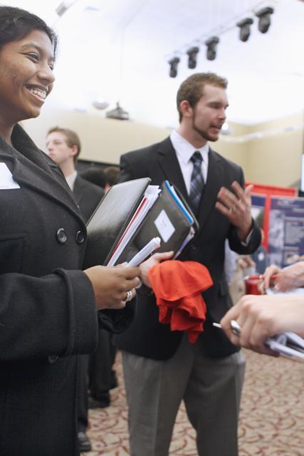 Priyanka Baratam, a senior in biological engineering, speaks with representatives from Fluor Corporation at the Spring Engineering Career Fair Wednesday. Baratam said she also went to the Fall Engineering Career Fair in hopes of picking up a full-time job after she graduates. &#8220;I want to find a science or engineering company. Not an agricultural company, because I see a lot of those here,&#8221; Baratam said. Photo by Lee Daniello.