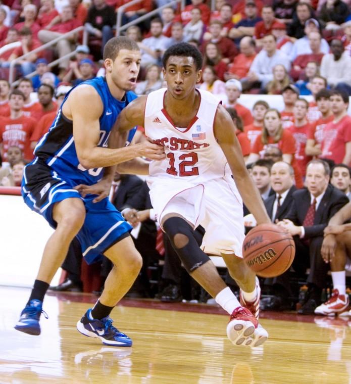 Freshman guard Ryan Harrow drives around Duke's Seth Curry at the RBC Center. The Wolfpack fell to the Blue Devils , 92-78.