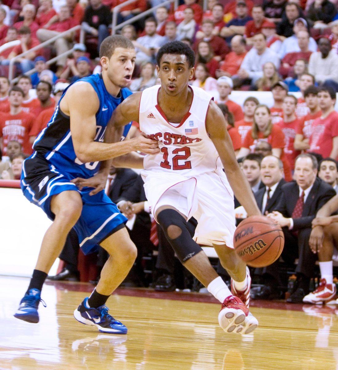 Freshman guard Ryan Harrow drives around Duke's Seth Curry at the RBC Center. The Wolfpack fell to the Blue Devils , 92-78.