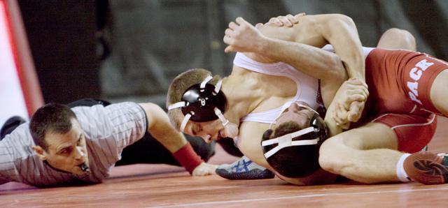 Matt Nereim, a freshman at 149-pounds, fights for a pin against Ohio University on Saturday, Jan. 22, at Reynolds Coliseum. Nereim pinned Ohio's Darrin Boing at the 3