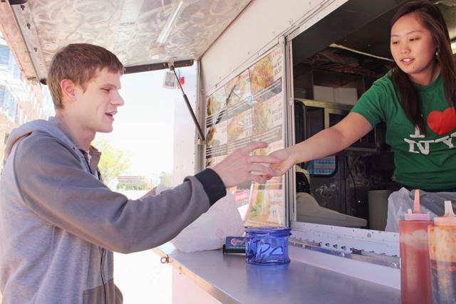 Joseph Henry, an alumn of N.C. State and an employee of Centennial Campus, receives his lunch from Bulkogi Korean BBQ Thursday, March 17. "It's good," Henry said. "I come every Thursday. The spicy bulkogi is the best." Photo by Kimberly Rochester