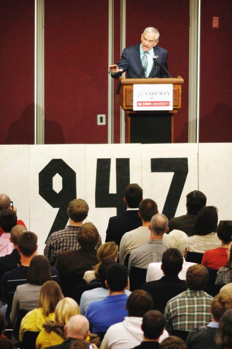 Texas Rep. Ron Paul speaks to a crowd of more than 1,000 at the McKimmon Center Monday. The N.C. State club Young Americans for Liberty collected 2,000 signatures to bring Paul to N.C. State to talk about national politics. "Mind our own business and take care of our country first," Paul said after spending quite some time describing conditions for war. "I am a fan of the Christian just war theory," Paul continued. "I don't even believe we should be in the United Nations." Photo by Tim O'Brien.