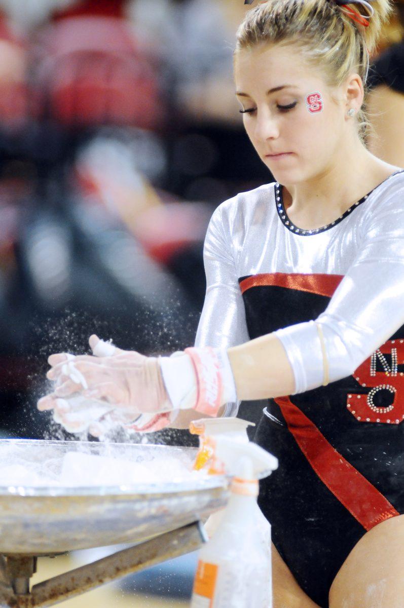 Junior Jess Panza rubs chalk on her hands as she gets ready to perform.