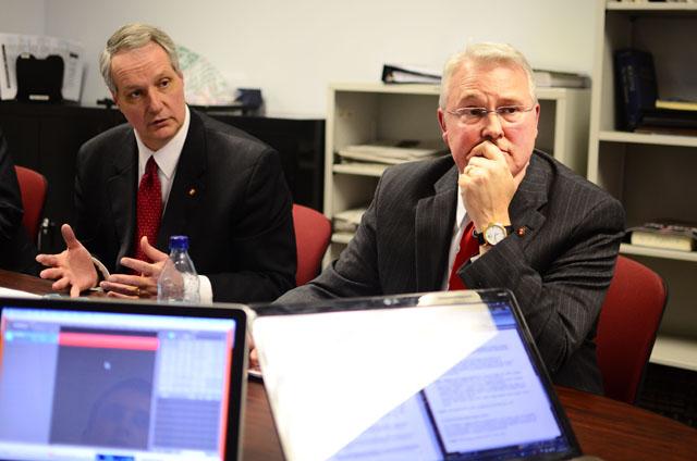 Provost Warwick Arden, left, answers staff questions about Chancellor Randy Woodson's plan for dealing with University system funding cuts from the state legislature in the Technician office on Monday. Photo by Alex Sanchez.