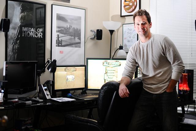 Independent developer Danny Green stands amongst the computers in his home office where he does the majority of work on his game, Gettysburg Armored Warfare, which will be released later this year. Photo by Luis Zapata