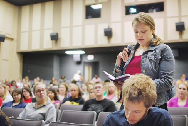 Elizabeth Knight, a senior in mathematics education, asks a question about tracking in schools during an open forum panel discussion on education Wednesday. Knight wants to be a high school math teacher. &#8220;I am going to be a teacher, and I have a lot invested in the North Carolina public school system as a teaching fellow,&#8221; Knight said. Photo by Sarah Tudor.