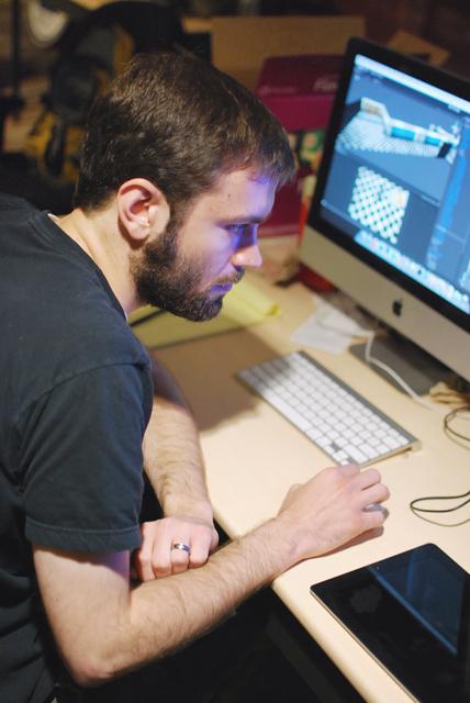 Josh Fairhurst, a 2010 N.C. State Alumnus and president and lead designer of Mighty Rabbit Studios, works on the first episode of his game, 'Saturday Morning RPG'. Photo by Sarah Tudor.