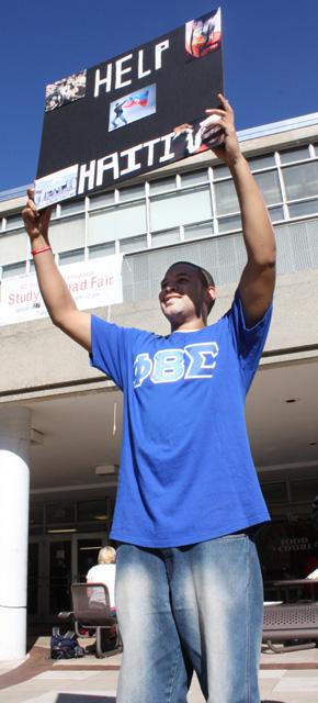 Elvin James, then a junior in First Year College, holds up a "Help Haiti" sign in front of the Atrium on Jan. 19, 2010. "We're from the Xi Zeta chapter of Phi Beta Sigma", said James. "We're collecting money for the Haiti relief, we're accepting donations." The fraternity was giving away pizza to anyone who gave a donation. Photo by Kimberly Rochester.