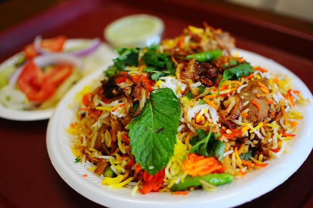 The chicken biryani from Laziz Biryani Corner is the specialty of the restaurant that reopened at its new location on Avent Ferry Road. Aisha Rashid, manager of the restaurant said, &#8220;Biryani is a very festive food with lots of color and rich flavor.&#8221; Photo by Brent Kitchen