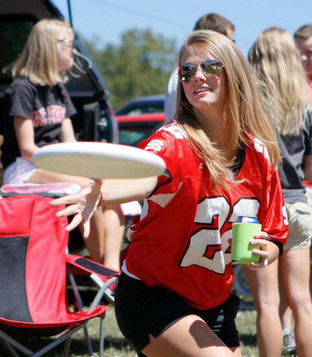 Kari Blevins, a senior in Psychology, throws a frisbee to some friends during pregame tailgating for the NC State - Western Carolina Football game on Sept. 4, 2010. "I tailgate all the time," Blevins said. "I'm a champion.". Photo by Kevin Cook