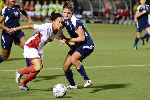 Senior forward Tanya Cain charges through a throng of ODU players to gain possession of the ball during the soccer game on Friday. Photo by John Joyner.