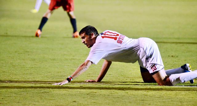 Redshirt freshman forward Nazmi Albadawi crawls forward after being knocked down after an attempt on goal on Friday. Photo by John Joyner.
