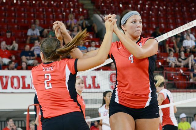 Freshman libero Alston Kearns and freshman outside hitter Nicole Glass high five during a substitution in the Wolfpack Challenge inside Reynolds Coliseum Aug. 20, 2011. Photo by Alex Sanchez