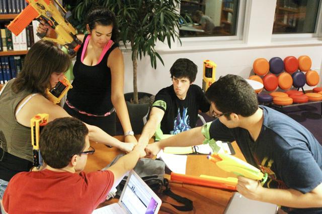 Marissa Bloomfield, sophomore in psychology, and her fellow classmates have a squad meeting in D.H. Hill library after the Humans vs. Zombies kickoff on Monday night. Photo by Greg Wilson.