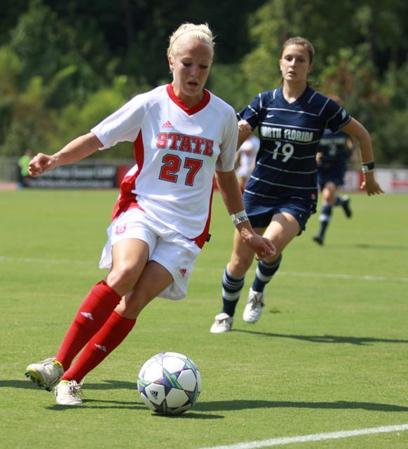 Dribbling into the box, freshman Stephanie Bronson cuts the ball away from opposing North Florida defenders. Bronson led the team with two goals in the Pack's 3-0 win against the University of North Florida on Sunday. Photo by Ryan Parry.
