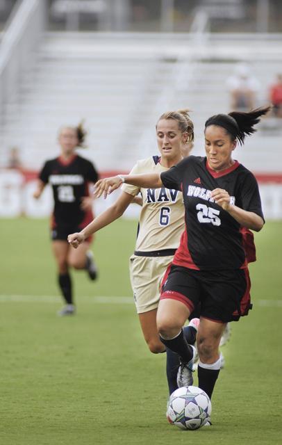 As the second half of the Sunday women's soccer game came to a close, forward Tanya Cain makes a drive for the goal with Navy's forward Sam Newhaller following close behind. Photo by Matt Nudi.