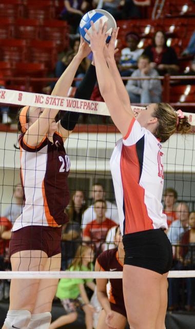 Junior setter Megan Cyr jousts with a Virginia Tech player during the volleyball game in Reynolds Colisseum on Friday, October 14. Photo by John Joyner.