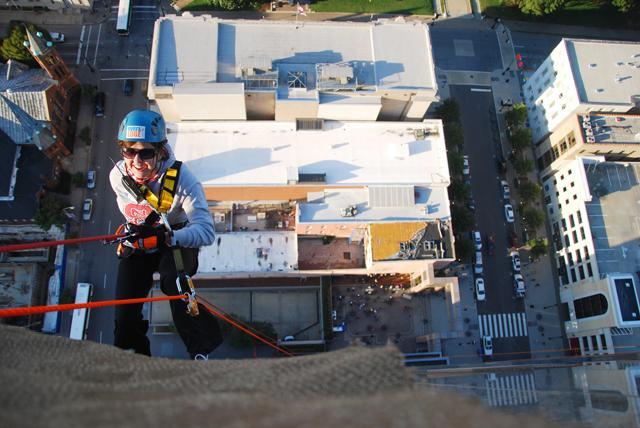 Sophomore in elementary education, Kelsie Morris is rappeling down the Wachovia Capitol Center/Wells-Fargo building on Oct. 1, 2011. Morris raised over 700 dollars to the special olympics. Morris descended 32 stories to raise money for the North Carolina Special Olympics. Photo by Ben Tran.