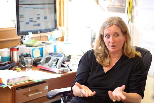 In her office, Heike Winter-Sederoff explains how her research on algae for use in biofuels has progressed. She, along with a team of other researchers, started the work two years ago, and they have just sequenced their algae samples. "We are just drowning in data," she said. Photo by Brett Morris.