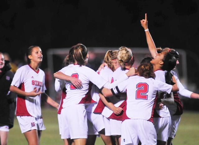 The team celebrates their win over the Clemson Tigers Thursday. Although the Tigers were the first to score, the Pack tied the game in the second half and eventually sent the game into overtime. Senior forward Tanya Cain scored the sudden-death goal and revived the squad&#8217;s post-season hopes to compete in the ACC Tournament. Photo by Nicole Moering.