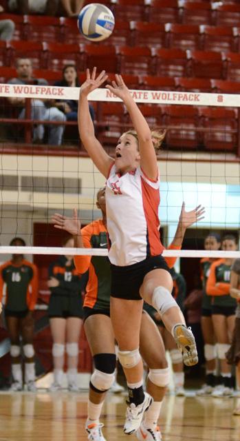 Redshirt junior setter Megan Cyr sets the ball during the volleyball game against Miami on Friday in Reynold's Coliseum. Photo by John Joyner.