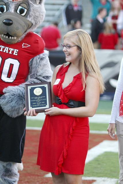 Caroline Funkhouser, a junior in media communication, recieves a award for Family of the Year at the NCSU Vs. Georgia Tech game, Saturday.