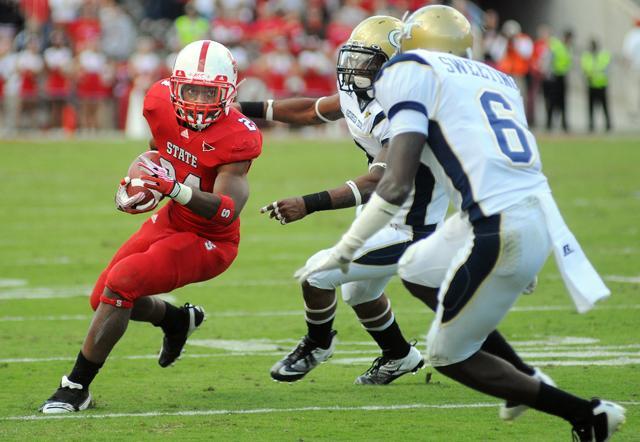 Junior halfback James Washington, is run down by Georgia Tech's Louis Young. In the third quarter, Washington scored the second touchdown for State with a 46-yard run, his longest run to date. Photo by Nicole Moering.