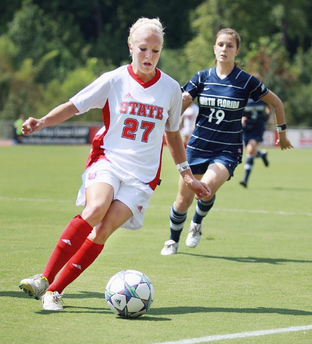 Dribbling into the box, freshman forward Stephanie Bronson cuts the ball away from opposing North Florida defenders. Bronson led the team with two goals in the Pack's 3-0 win against the University of North Florida. Photo by Ryan Parry.