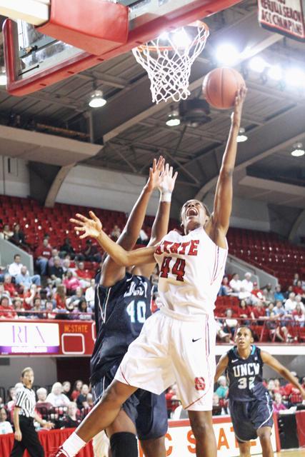 Kody Burke, a freshman forward, leaps towards the basket and scores against UNCW at Reynolds Coliseum, Nov. 16. Photo by Sandra Edwards.