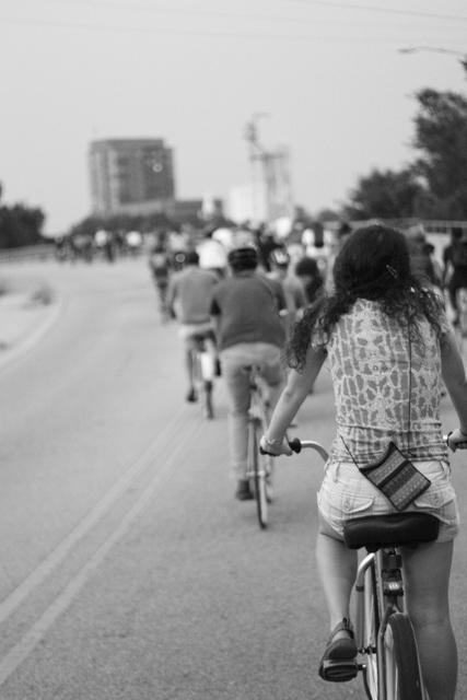 Crossing over the bridge on Boylan Avenue, the bikers riding in Raleigh's monthly First Friday Bike Ride head out from their first stop at Rebus Works Friday, September 2nd. The route would then take them dowtown, entire intersections being shut down for the cavalcade as it made its way to its second stop, Lump. Photo by Brett Morris.