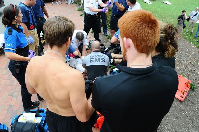 Jon Smetana, a junior in sport management, and Robert, a passing runner, stand overlooking Spencer Shell on Dan Allen Drive as paramedics perform chest compressions Sept. 2, 2010. Smetana and Robert were the first on the scene, performing CPR until EMS arrived. A new class finishing its first semester, PEH 300, includes the option to become a certified emergency medical technician. Photo by Brent Kitchen
