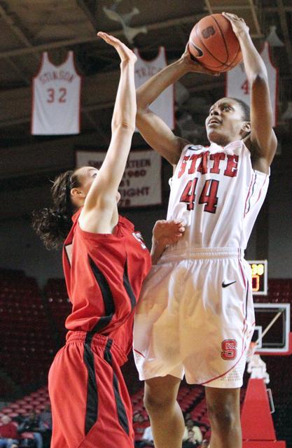 Kody Burke, a sophomore forward, towers over a Southeast Missouri player as she goes for the shot at Friday's game November 11, 2011. Burke picked up 6 points for N.C. State, and aided in securing the the Wolfpack's win, 66-29. Photo by Vanessa Movasseghi.