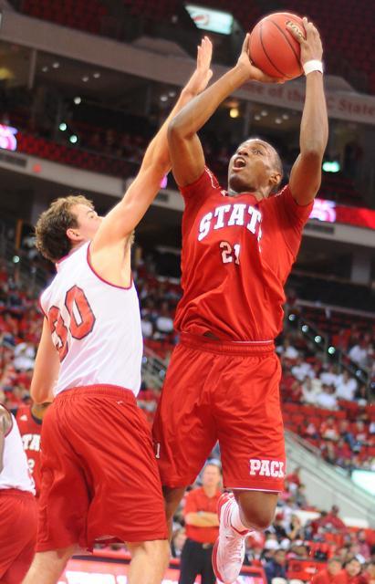 Senior guard C.J. Williams puts a shot up over freshman guard Staats Battle during the team's Red and White scrimmage at the RBC Center Saturday, Nov. 5. Photo by Brent Kitchen