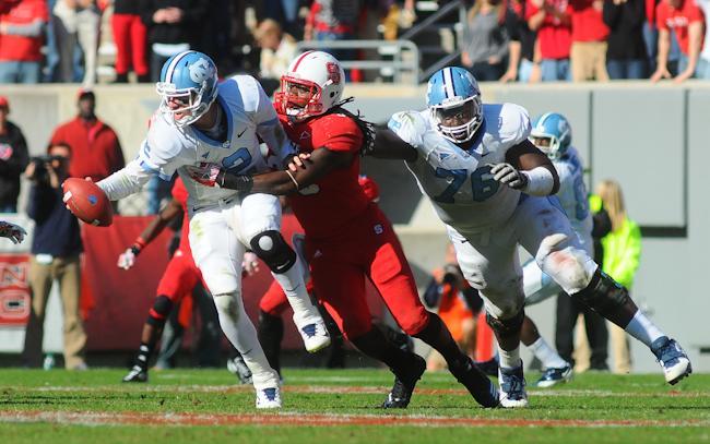 Redshirt senior linebacker Terrell Manning sacks Carolina quarterback Bryn Renner during the team's game at Carter-Finley Stadium on Saturday. Manning led the Pack with 11 tackles as State defeated the Tar Heels, 13-0, for its fifth consecutive win in the rivalry. Photo by Brent Kitchen.