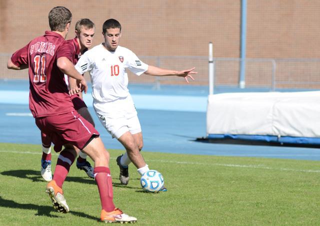 Sophomore forward Nazmi Albadawi moves the ball past two Virginia Tech players during the first round of the ACC Men's Soccer Tournament on Fetzer Field in Chapel Hill on Monday, Nov. 7, 2011. The Wolfpack would defeat the Hokies 1-0, moving them on to the next round against UNC Chapel Hill. Photo by John Joyner.