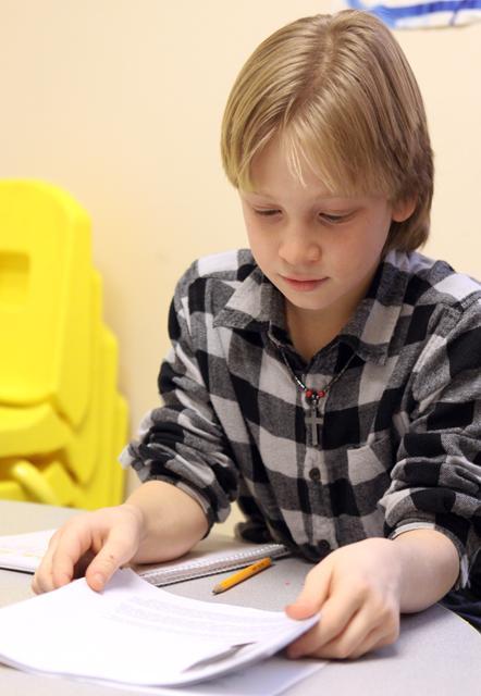A student at The Daniel Center for Math and Science works on his science fair project on biofuel, on Friday 13th, 2012. Photo by Thomas Obarowski